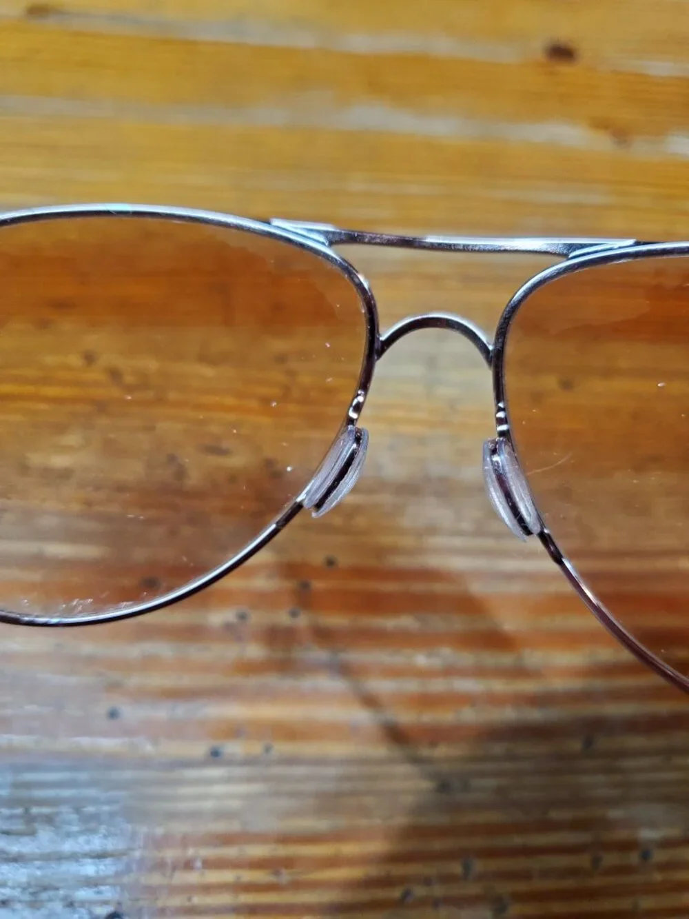 Oakley Caveat aviator sunglasses featuring a rose gold metal frame and warm brow